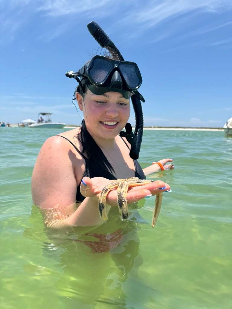 Snorkeling at Shell Island holding starfish